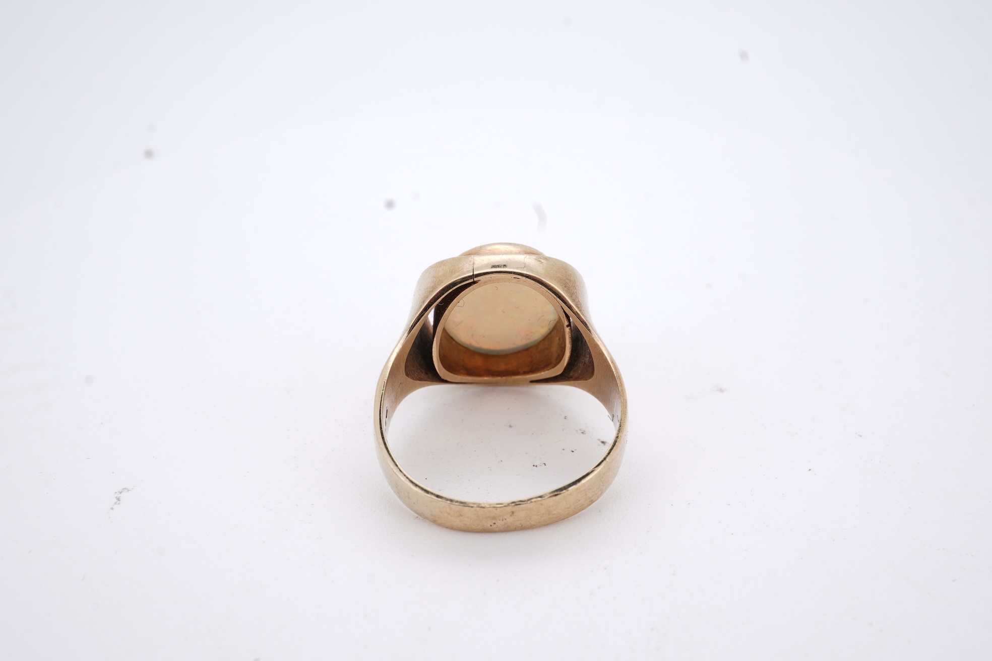 A 9ct and single stone cabochon white opal set ring, size K/L, gross weight 5 grams.
